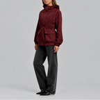 Side profile view of the burgundy jacket worn with wide-leg jeans and ankle boots