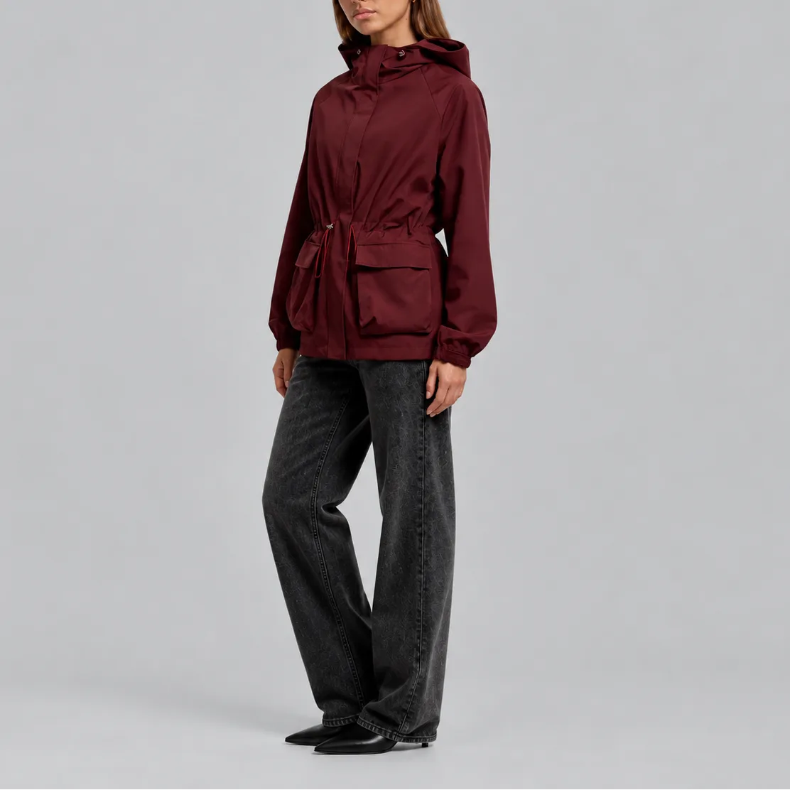 Side profile view of the burgundy jacket worn with wide-leg jeans and ankle boots