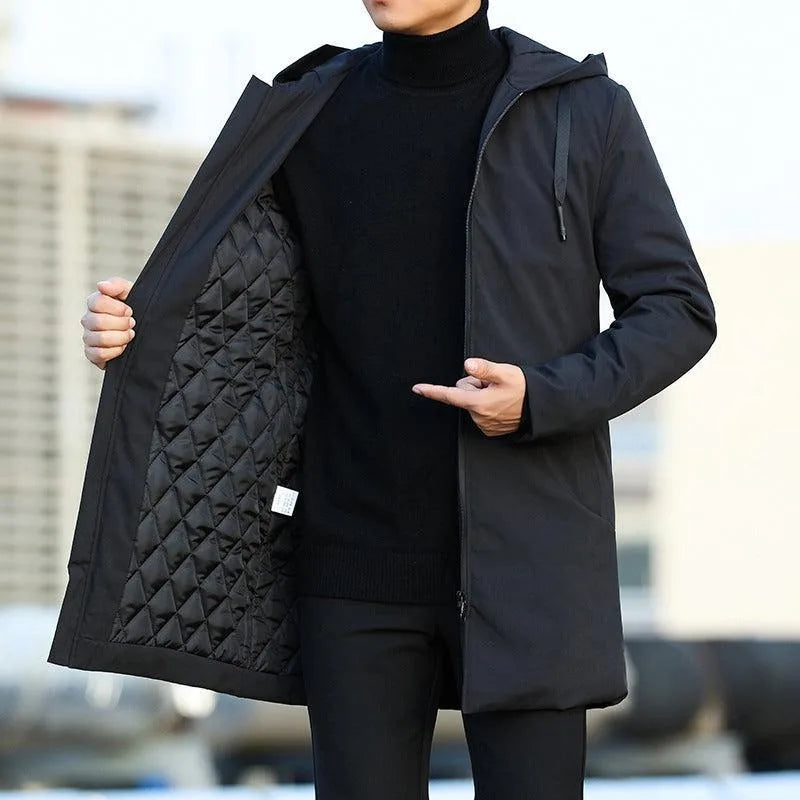Man wearing a black hooded parka open at the front, revealing the black diamond-quilted thermal lining and zip fastening.