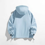 Back view of the light blue hooded jacket showing the relaxed fit and elasticated cuffs