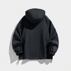Back view of the black hooded jacket highlighting the oversized hood and elasticated cuff tabs