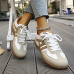 Close-up of the heel and lace detail showing the mixed suede and leather-look panelling in cream and tan