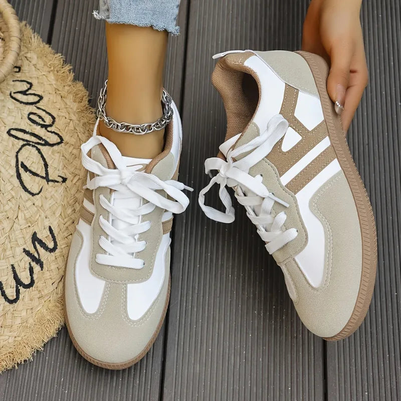 Top-down view of both trainers side by side, showing matching white laces and symmetrical taupe stripe design