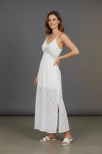 Close side angle of the white lace maxi dress highlighting the fitted empire waist and delicate crochet-style texture