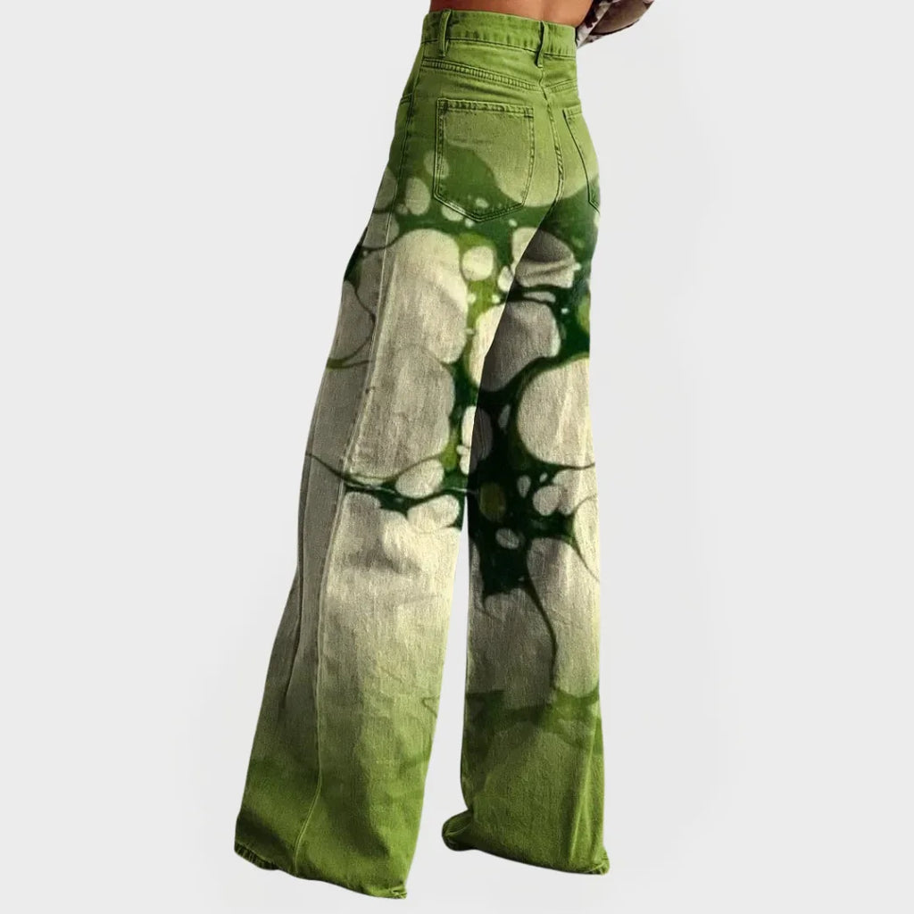 Side profile of the wide-leg tie-dye jeans showing the back pocket detail and flared denim silhouette.