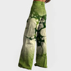 Side profile of the wide-leg tie-dye jeans showing the back pocket detail and flared denim silhouette.