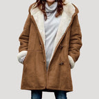 Camel brown duffle coat with cream borg lining and wooden toggle fastenings, hands tucked into the pockets