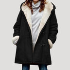 Black duffle coat with cream fleece-lined hood and collar, shown open over a grey knit jumper