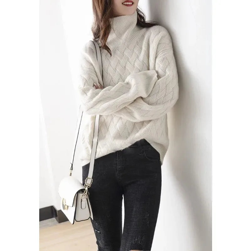 Woman wearing a cream woven-pattern polo neck jumper with dark jeans and a white crossbody bag