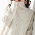 Close-up front view of the ribbed polo neck collar and chunky woven knit texture in cream