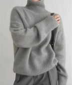 Front close up of cream ribbed polo neck collar with model's hand adjusting the neckline