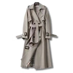 Light grey trench coat with buckled cuffs and matching fabric belt, full front view