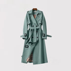 Sage green trench coat with double-breasted buttons and buckled cuff straps, front view