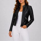 Black faux leather jacket with silver zip pockets and snap-button cuff, worn with white jeans