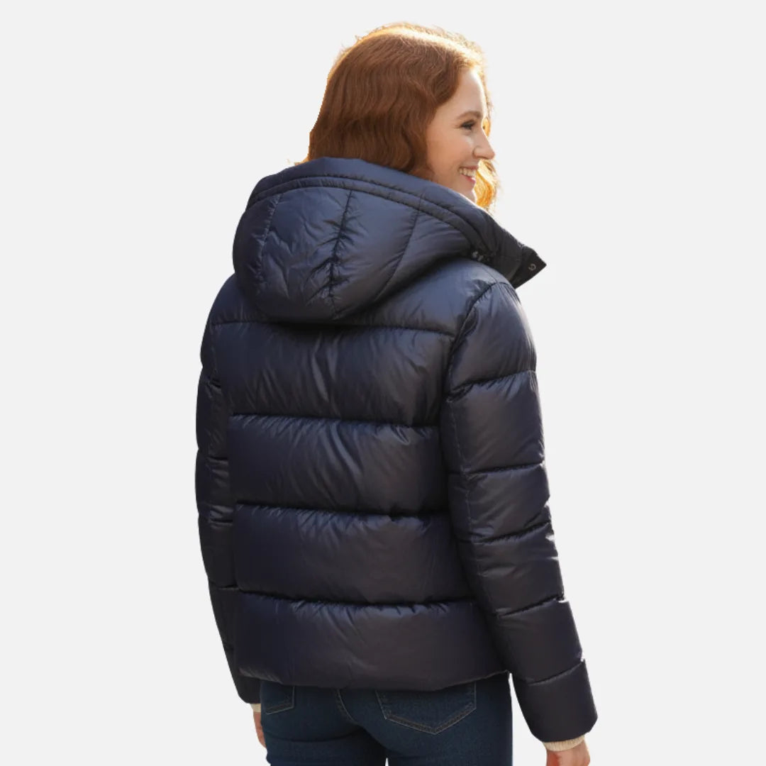 Back view of the navy puffer jacket showing the quilted panels and attached hood
