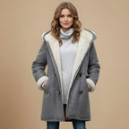 Front view of a grey hooded duffle coat with cream shearling-style lining, toggle fastenings and a grey polo neck jumper