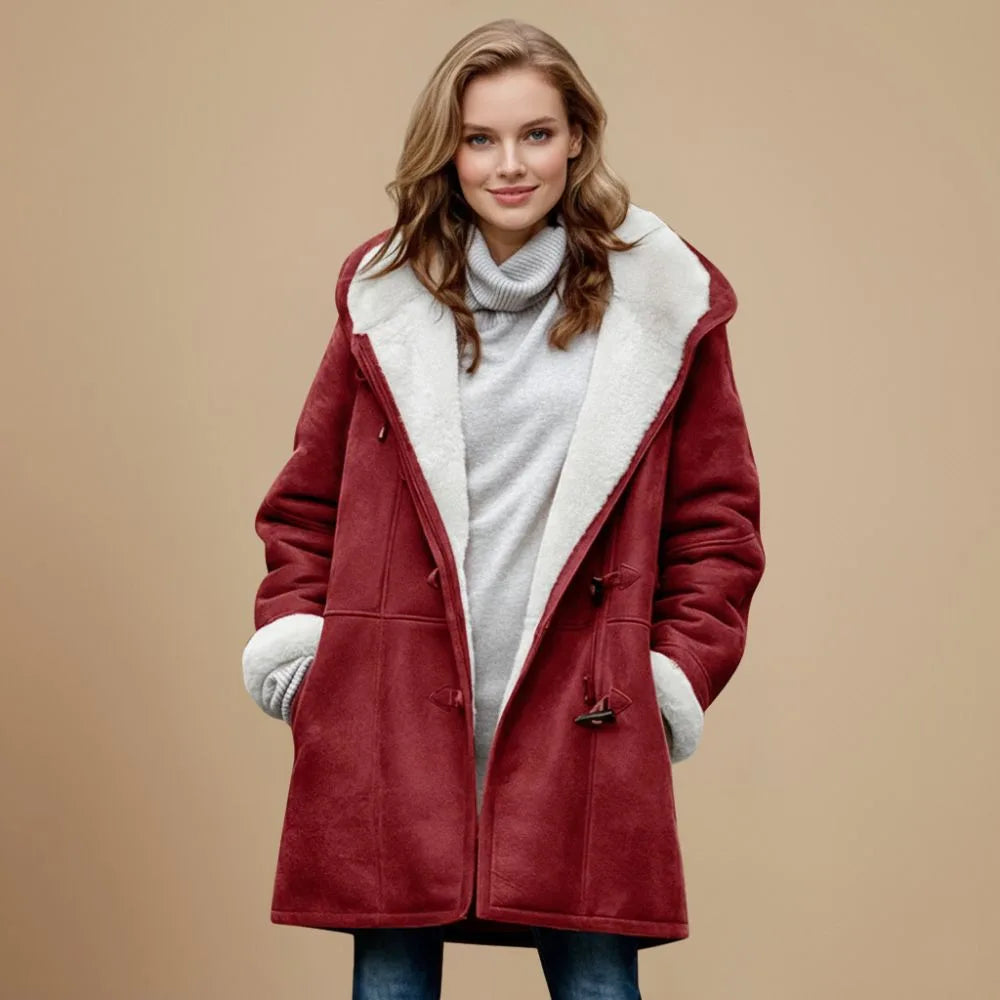 Front view of a deep red duffle coat with cream fleece lining, hood and toggle fastenings, hands in pockets
