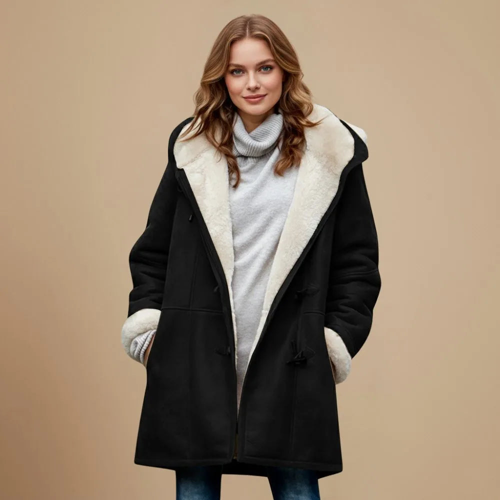 Front view of a black hooded duffle coat with cream fleece lining and toggle fastenings worn over denim