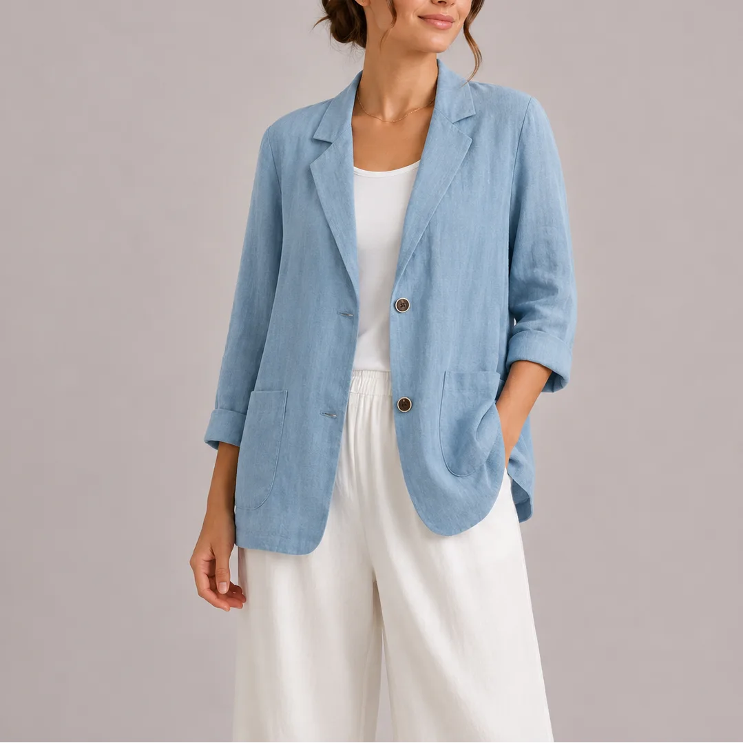 Close-up front view of a light blue linen blazer worn open over a white top, showing rolled cuffs and patch pockets