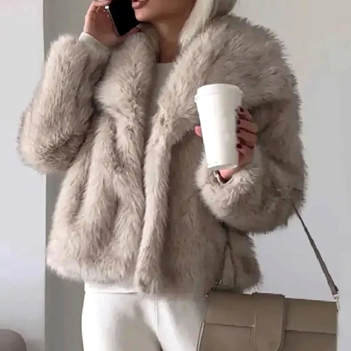 Beige faux fur cropped jacket with open front and long sleeves, shown paired with white trousers