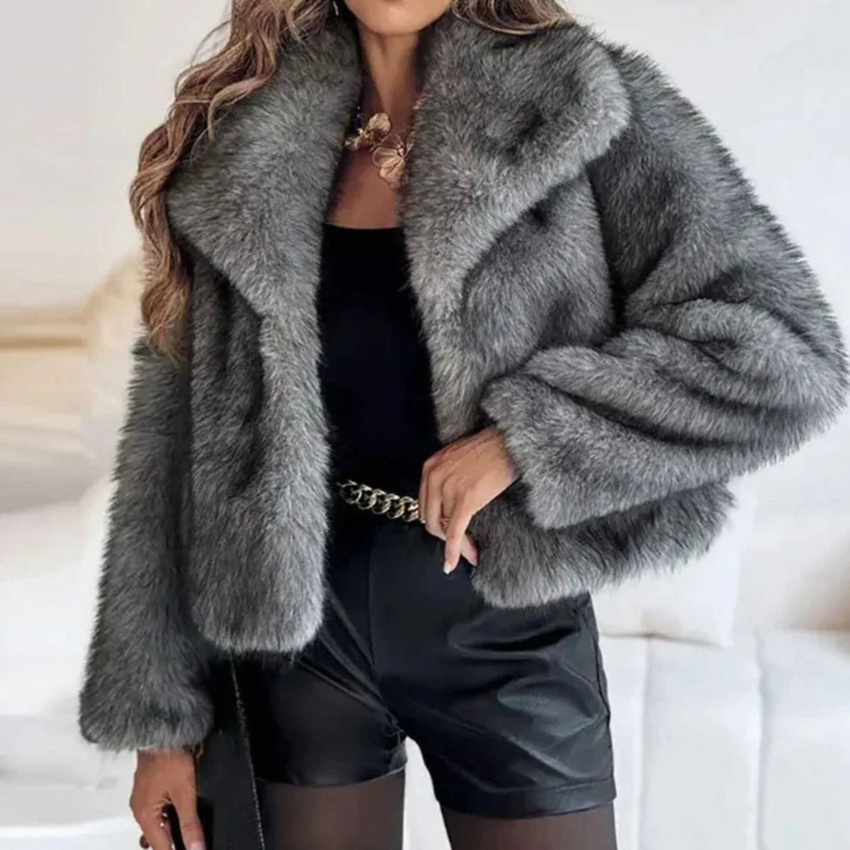 Charcoal grey faux fur cropped jacket with wide lapel collar styled with a black top and chain belt
