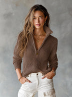 Front view of a brown open-knit half-zip jumper with collar worn with white cargo-style trousers