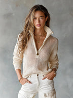 Front view of a beige open-knit half-zip jumper with collar, hands in pockets of white trousers