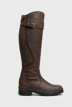 Side view of a dark brown leather knee-high boot with buckle strap at the top and chunky black lug sole