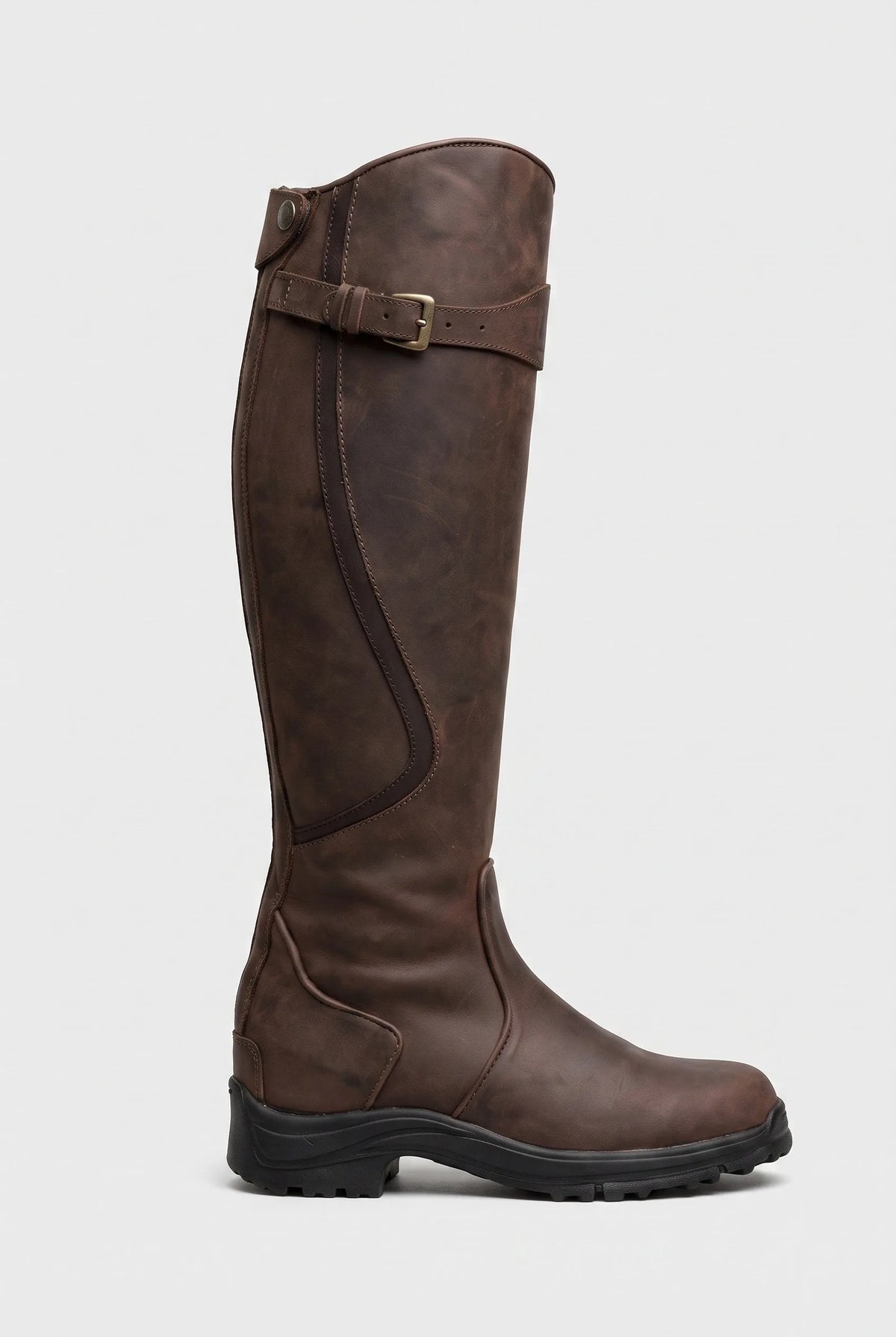 Side view of a dark brown leather knee-high boot with buckle strap at the top and chunky black lug sole