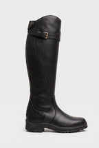 Side view of a matte black knee-high leather boot with buckle strap and sturdy ridged sole