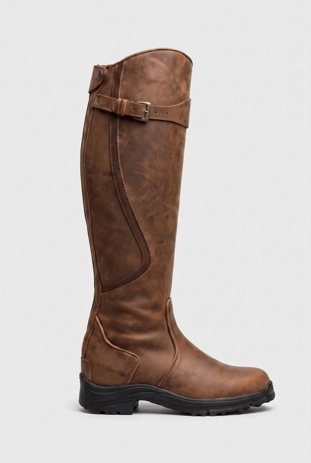 Side view of a tan brown knee-high leather boot with contrast stitching, buckle strap and grippy lug sole