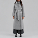 Front view of a woman wearing a grey wool-style wrap coat with wide stand collar and tie belt