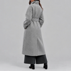 Back view of the grey wrap coat showing raglan sleeves and the tied waist belt