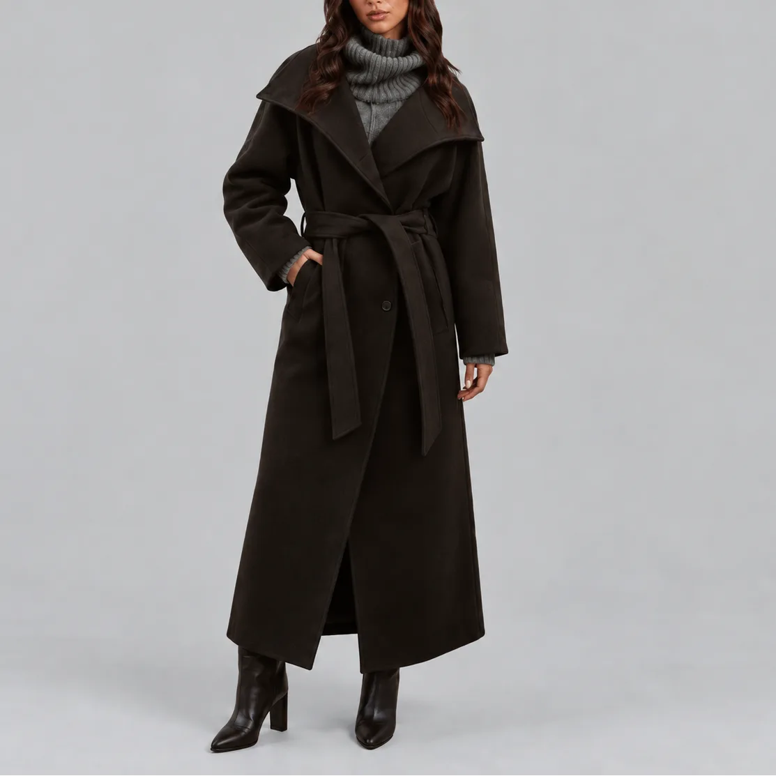Front view of a dark brown belted wrap coat with wide collar worn over a knit polo neck